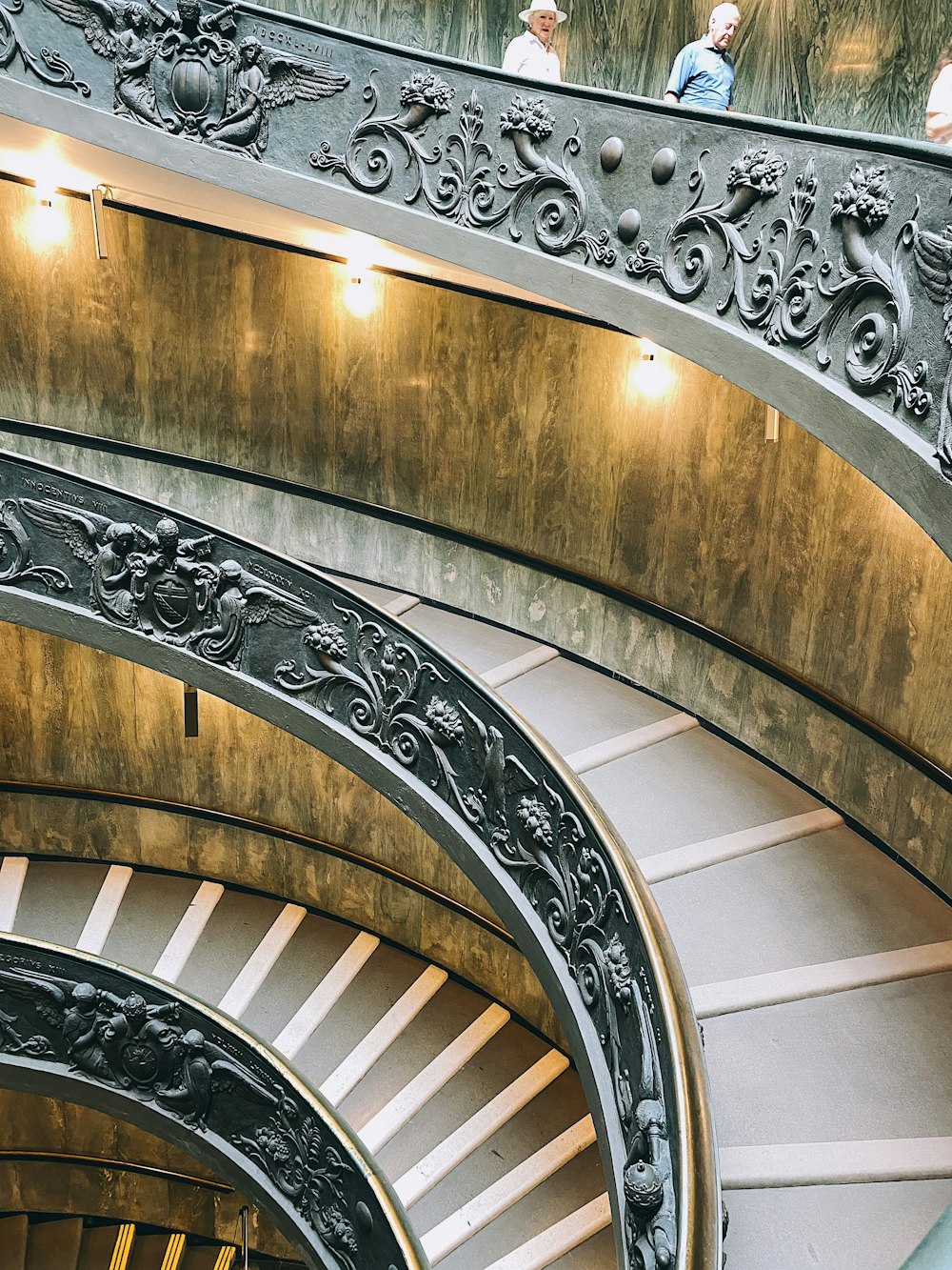 a group of people standing on top of a spiral staircase