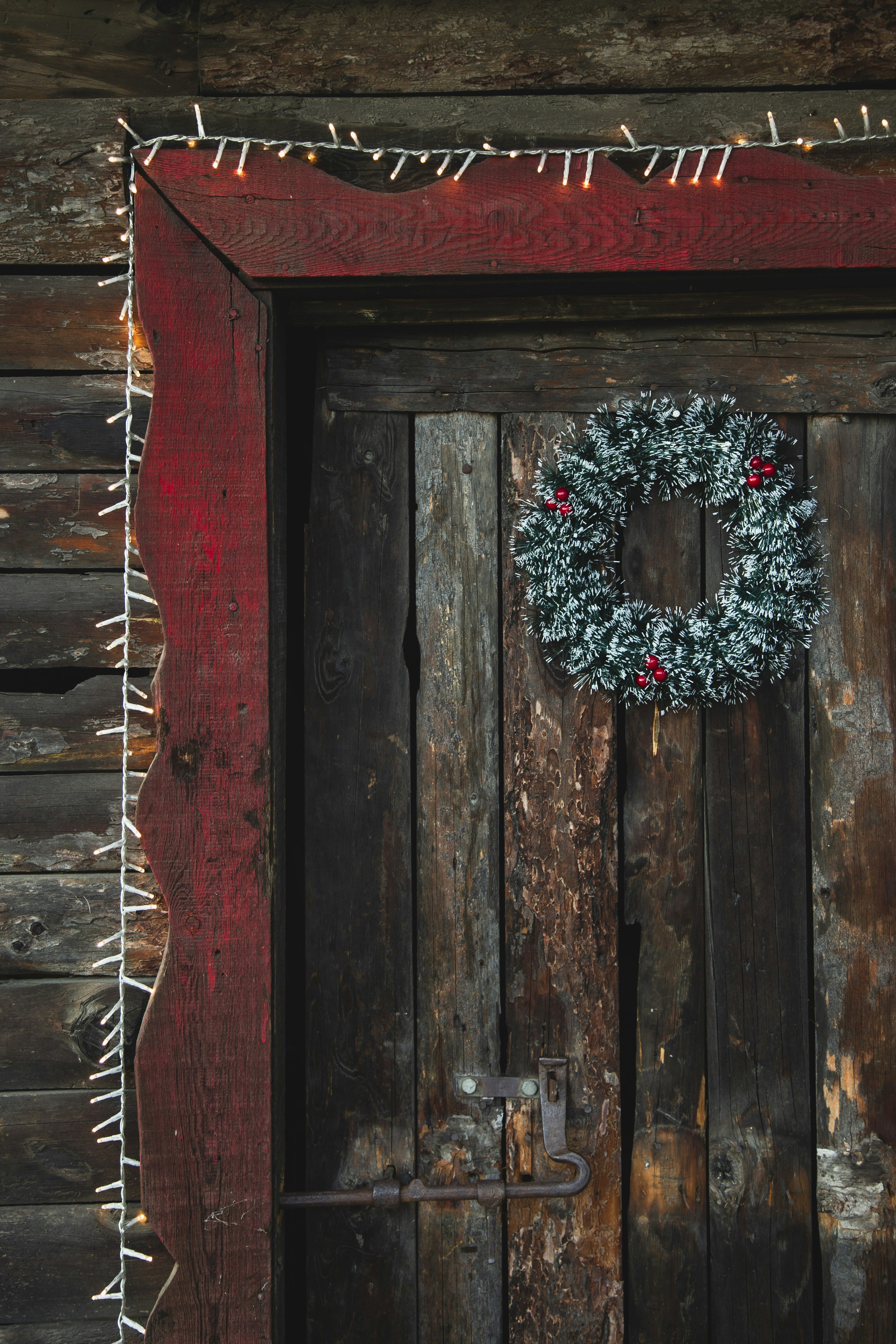a wooden door with a wreath on it