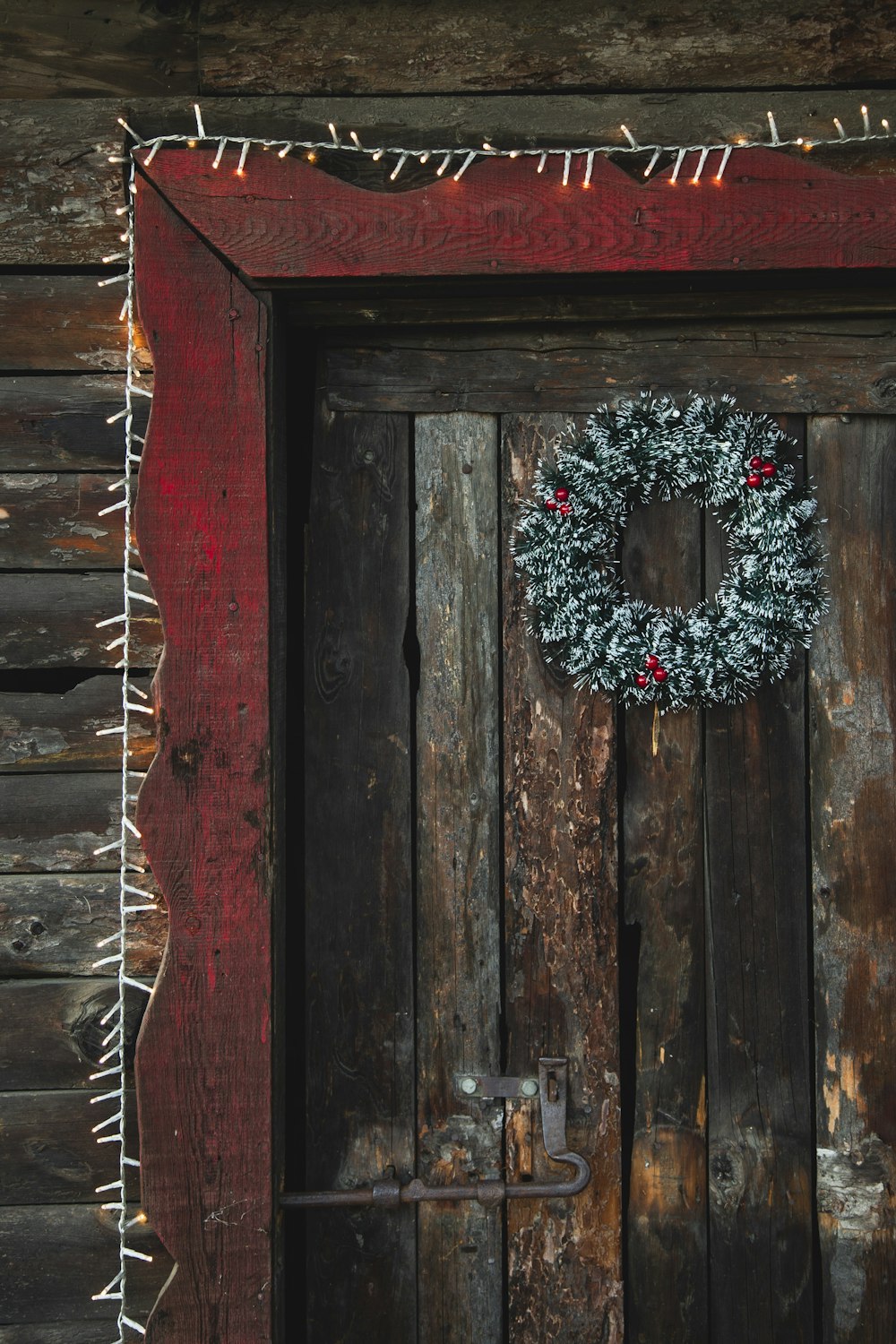 a wooden door with a wreath on it