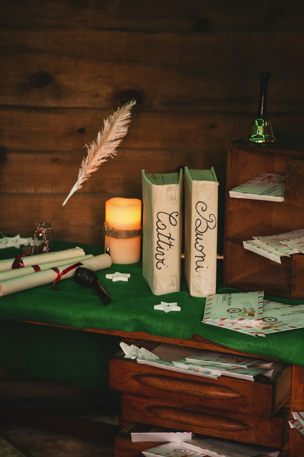 a table topped with books and a candle