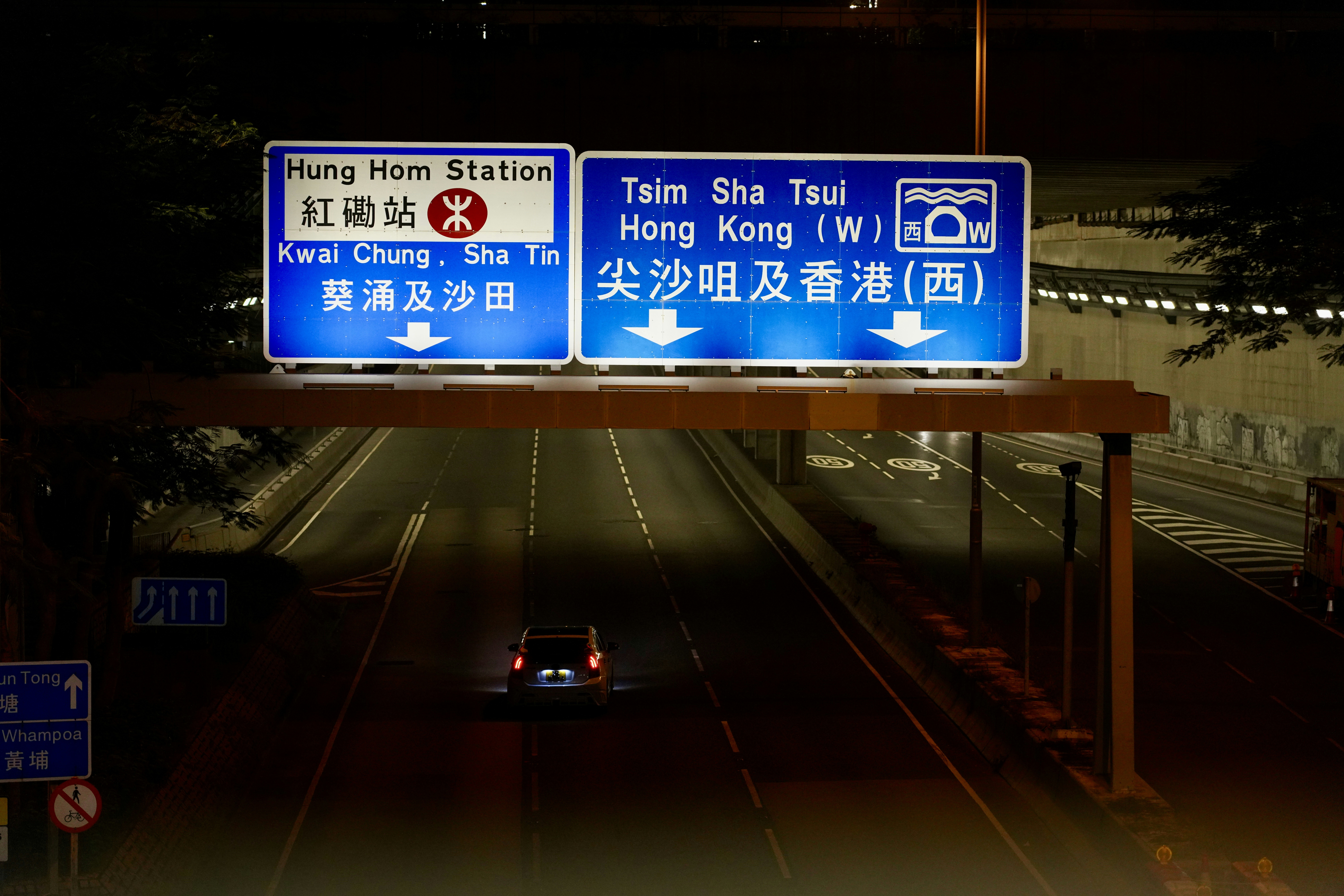 a car driving down a street at night
