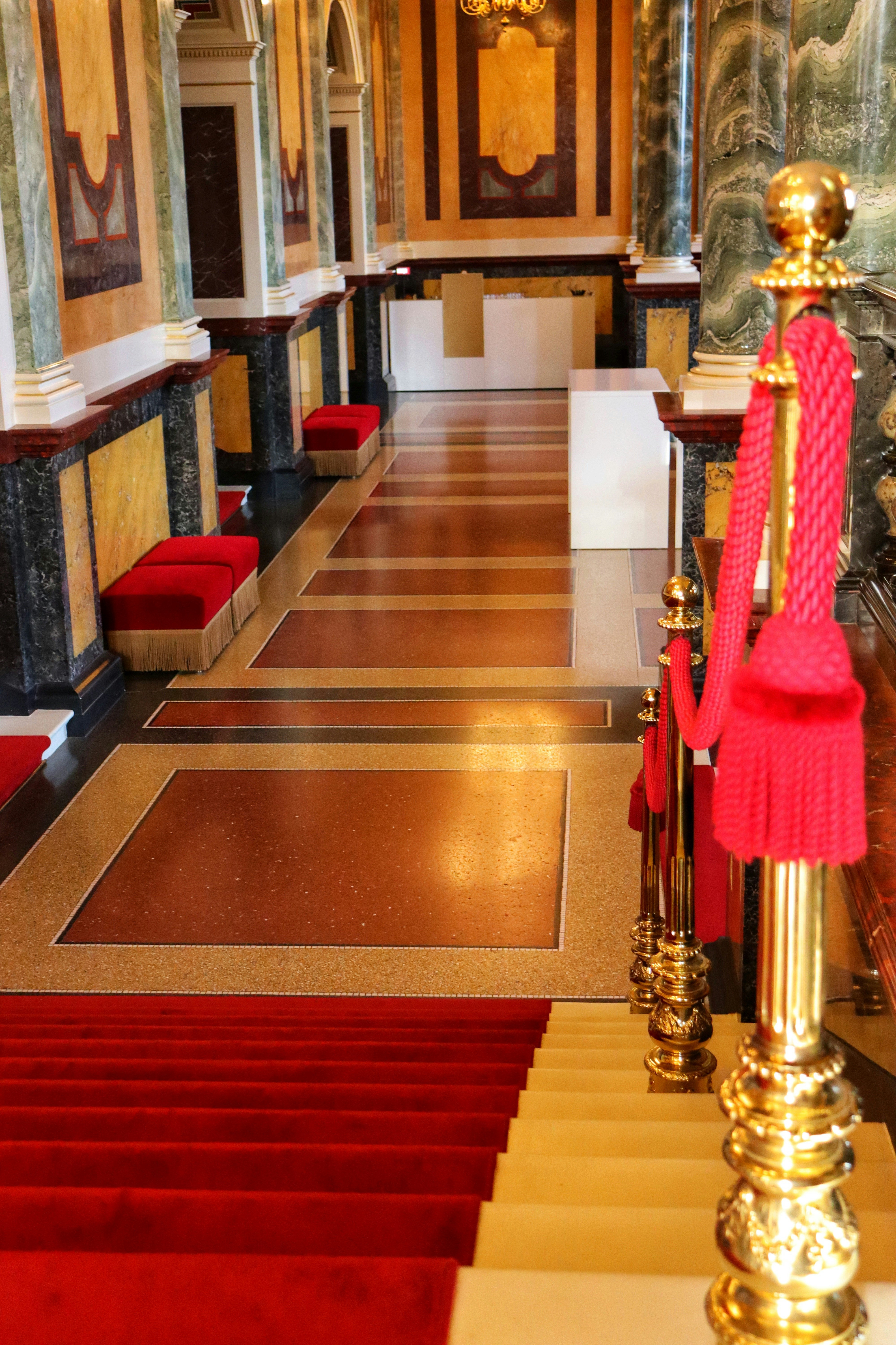 A red carpeted hall with a gold railing and red carpet photo – Free ...
