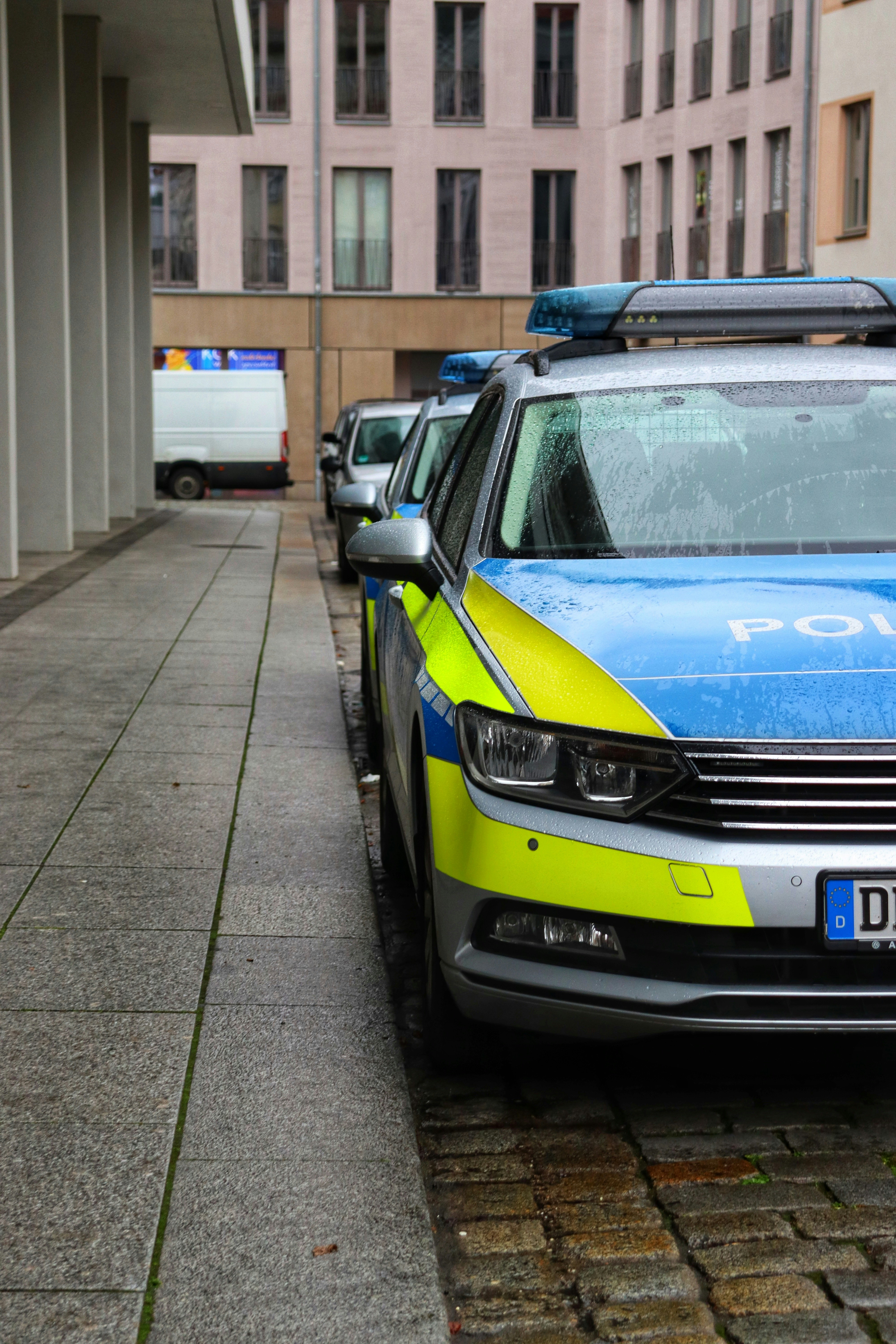 a blue and yellow car parked on the side of a street