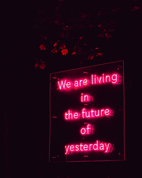 a neon sign that says we are living in the future of yesterday