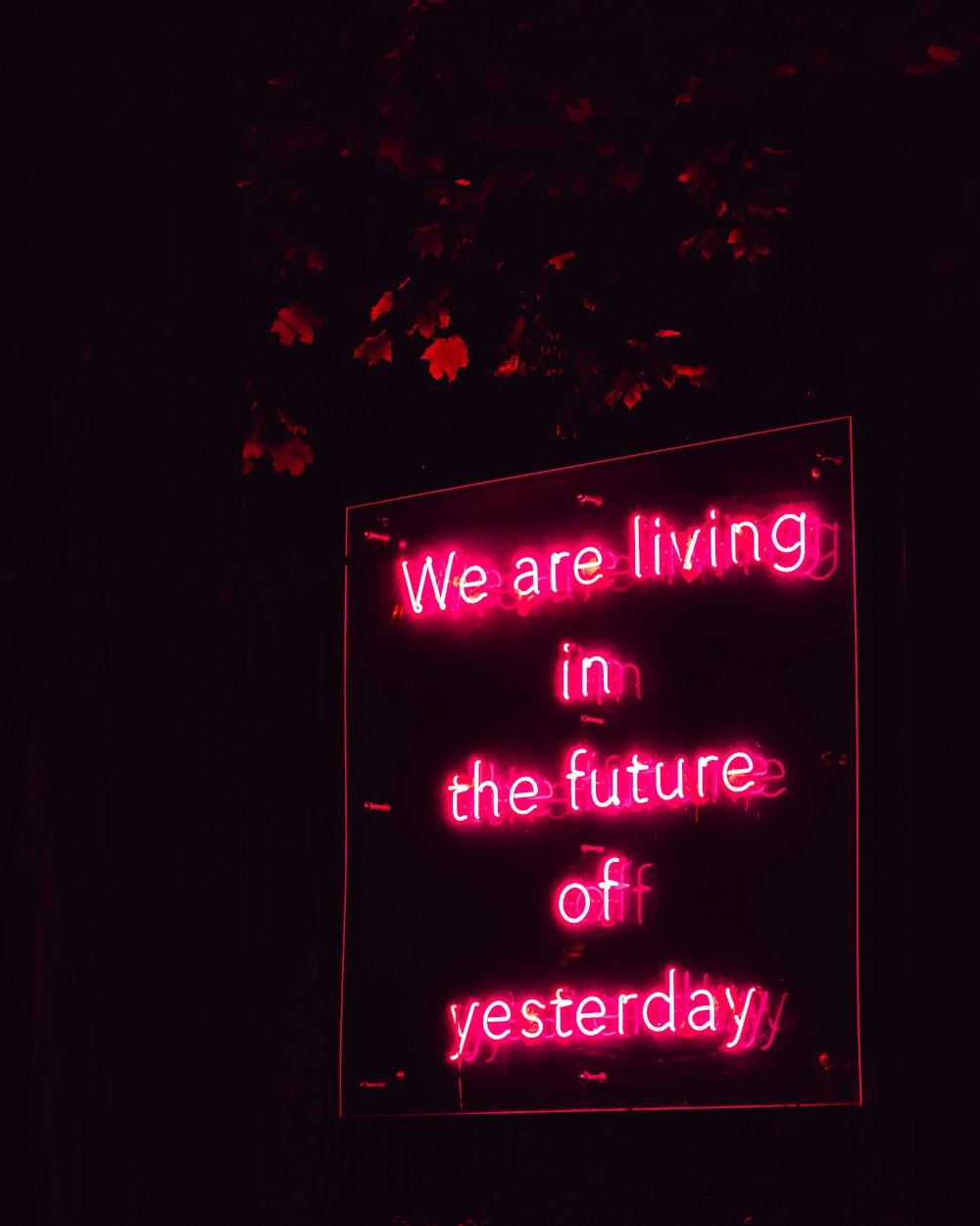 a neon sign that says we are living in the future of yesterday