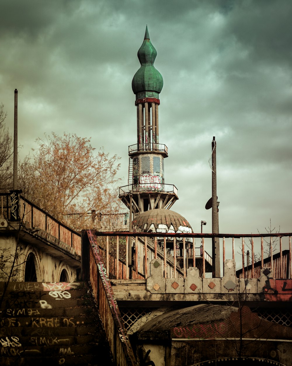 a tall tower with a green top on top of a building