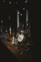 A dimly lit shelf filled with vintage glass potion bottles glowing faintly.