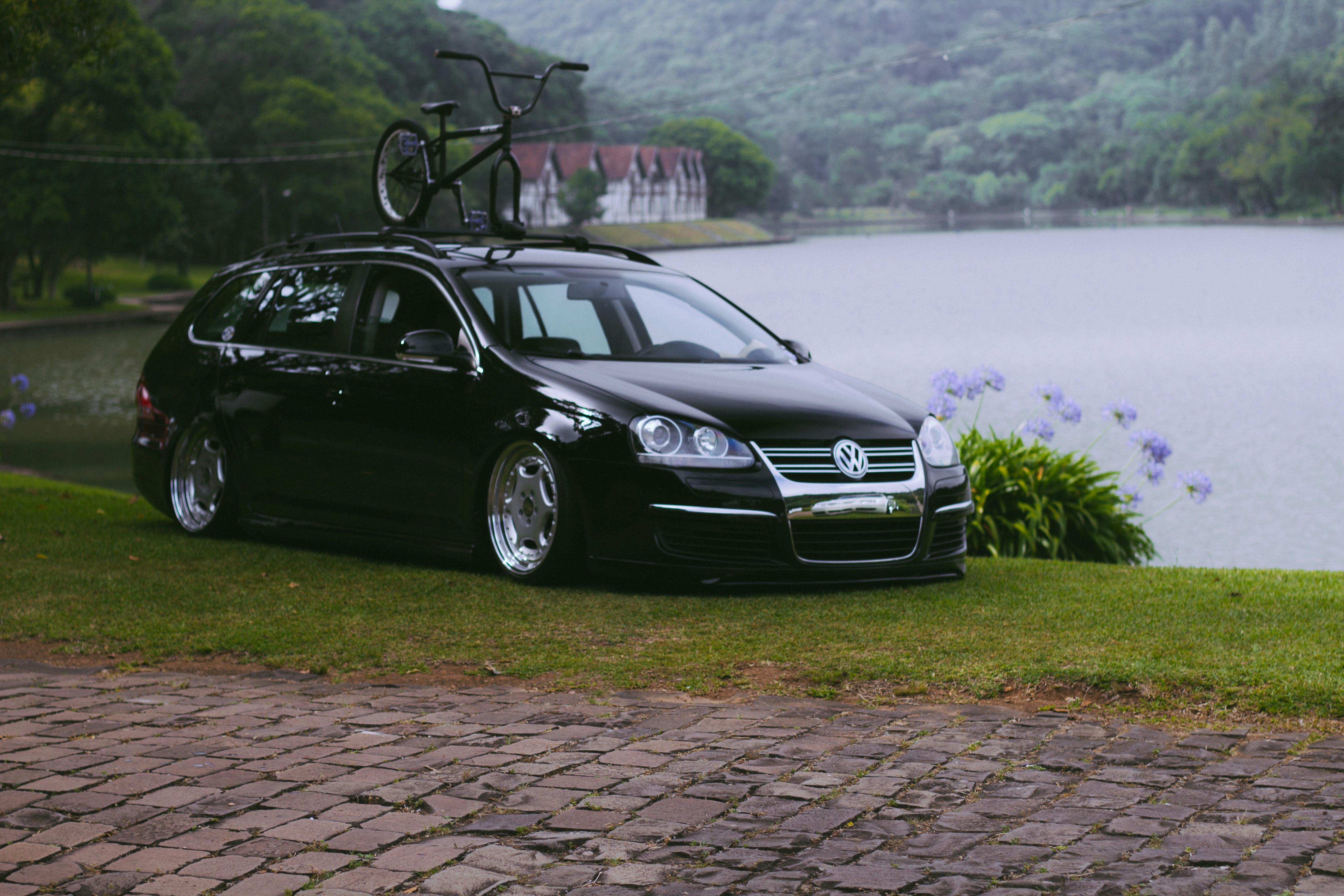 a black car with a bike on top of it
