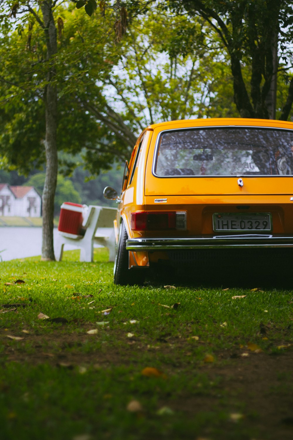 a yellow car is parked in the grass