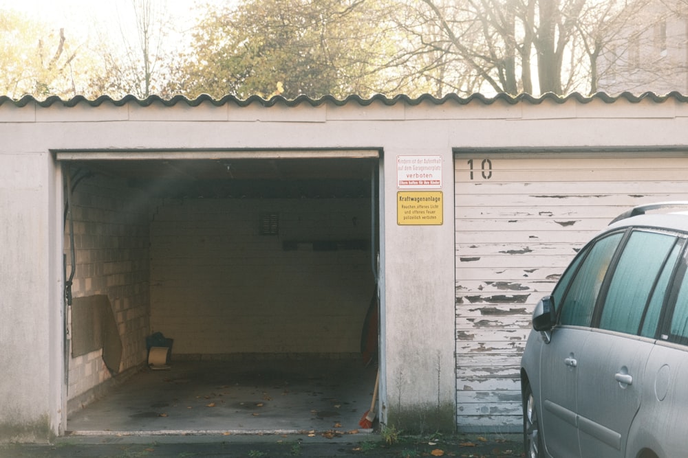 a car parked in front of a white building