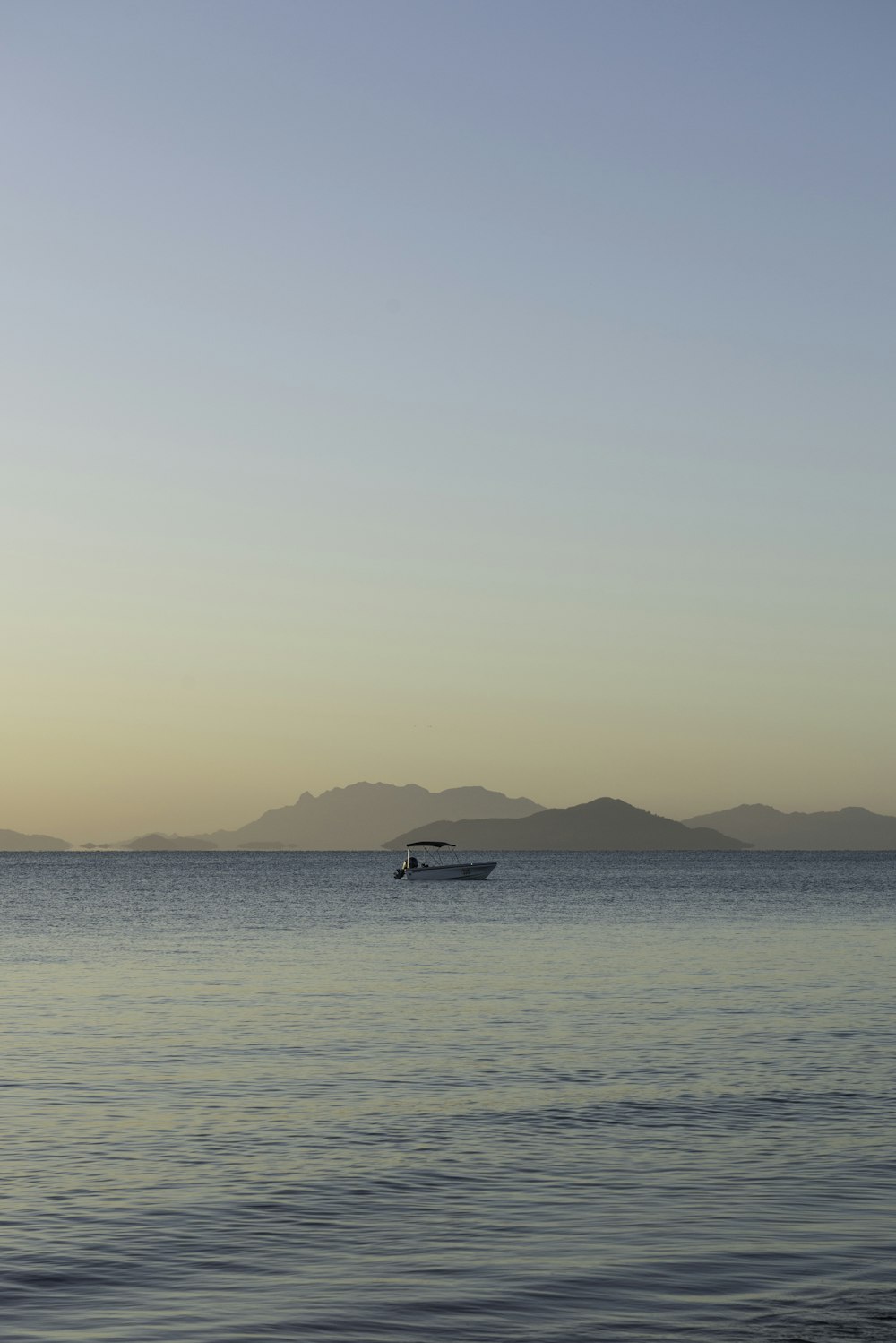 a small boat in the middle of a large body of water