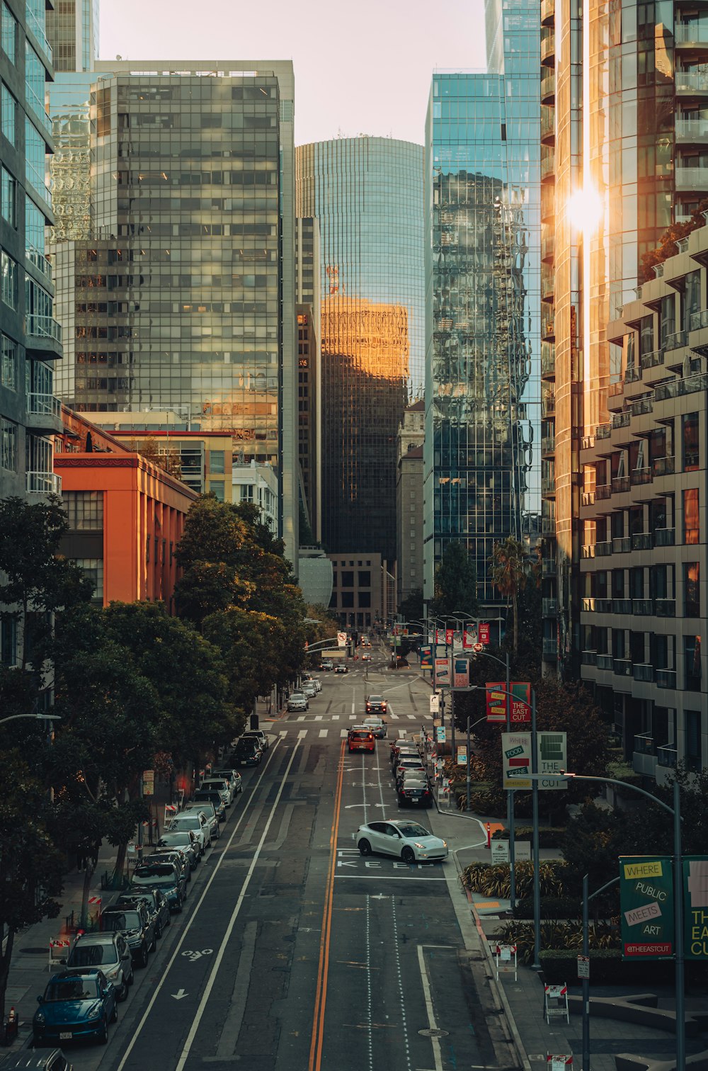 a view of a city street with tall buildings