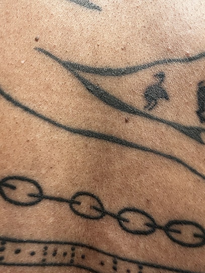 A close-up of intricate tattoo designs on skin.