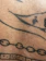 Close-up of a fresh black and grey tattoo on forearm with clean lines and shading.