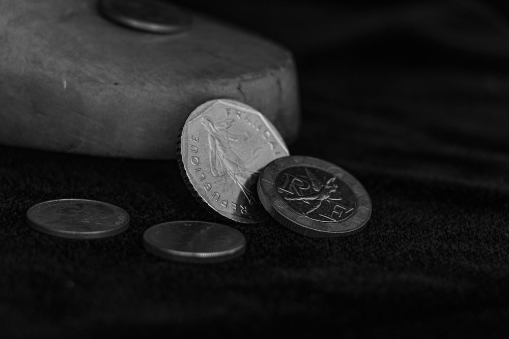 a close up of a rock and two coins