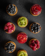 a group of fruit tarts sitting on top of a table