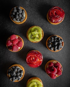 a group of fruit tarts sitting on top of a table