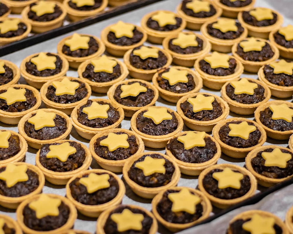 a tray of cookies with yellow stars on them