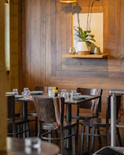 a restaurant with wooden walls and tables and chairs