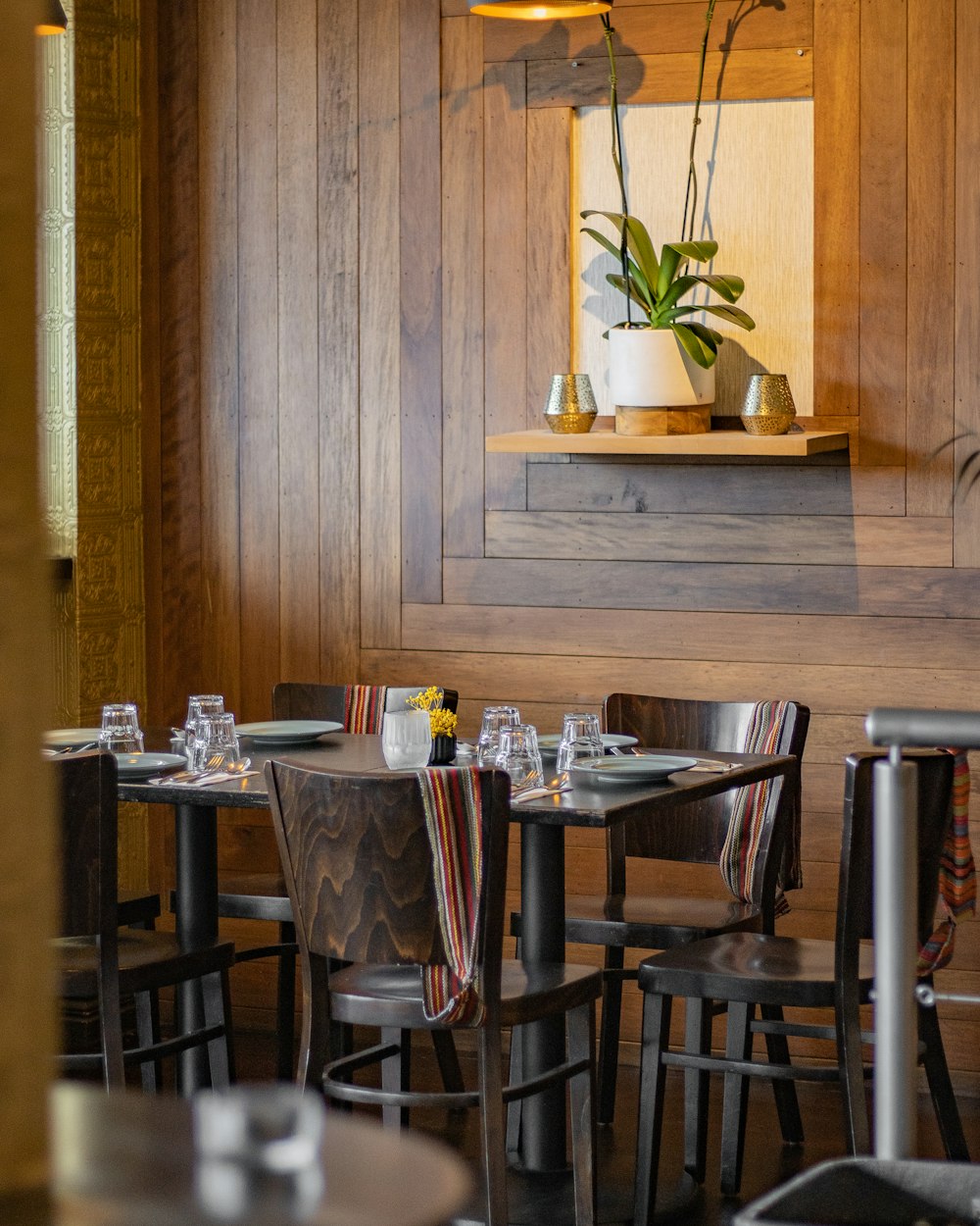 a restaurant with wooden walls and tables and chairs