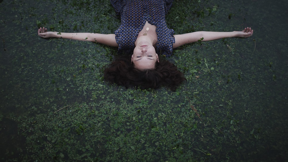 a woman laying on the ground with her eyes closed