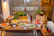 Close-up of a modern buffet table with fresh salads, artisan breads, and vibrant dips.