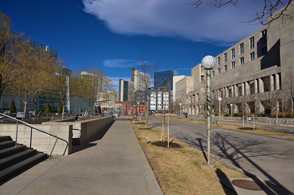 a city street lined with tall buildings and trees