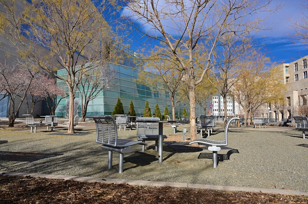 a group of benches sitting next to each other in a park