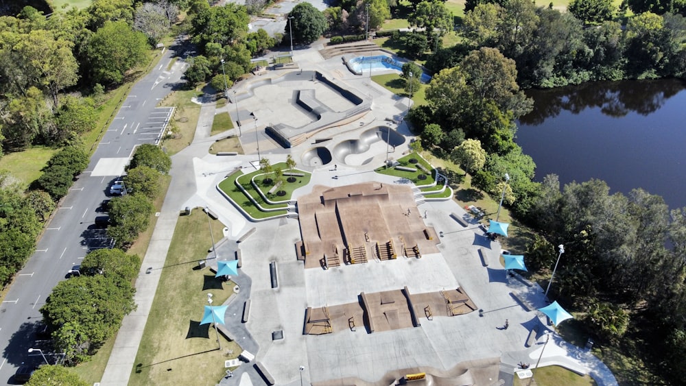 an aerial view of a skate park with a lake in the background