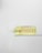 A bottle of Collagen Cleansing Oil with a pump dispenser is placed horizontally on a transparent surface, with the liquid slightly oozing out. The bottle is clear, revealing the yellowish oil inside. The label features product information in red and black text.