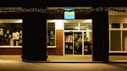 A small business storefront with a digital sign showing positive customer reviews.