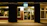 Outdoor storefront illuminated by vibrant LED curtain lights at dusk.