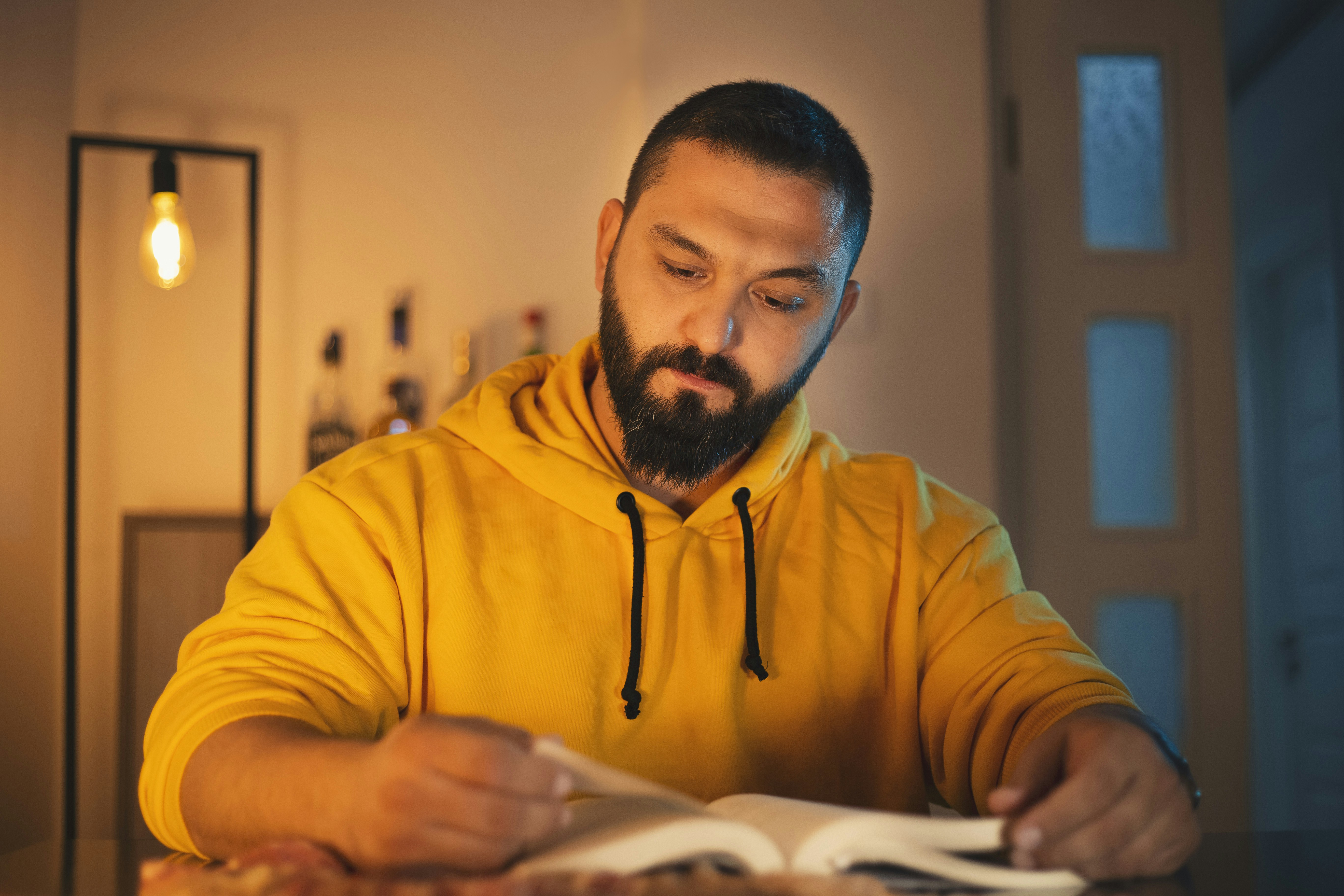 a man sitting at a table reading a book