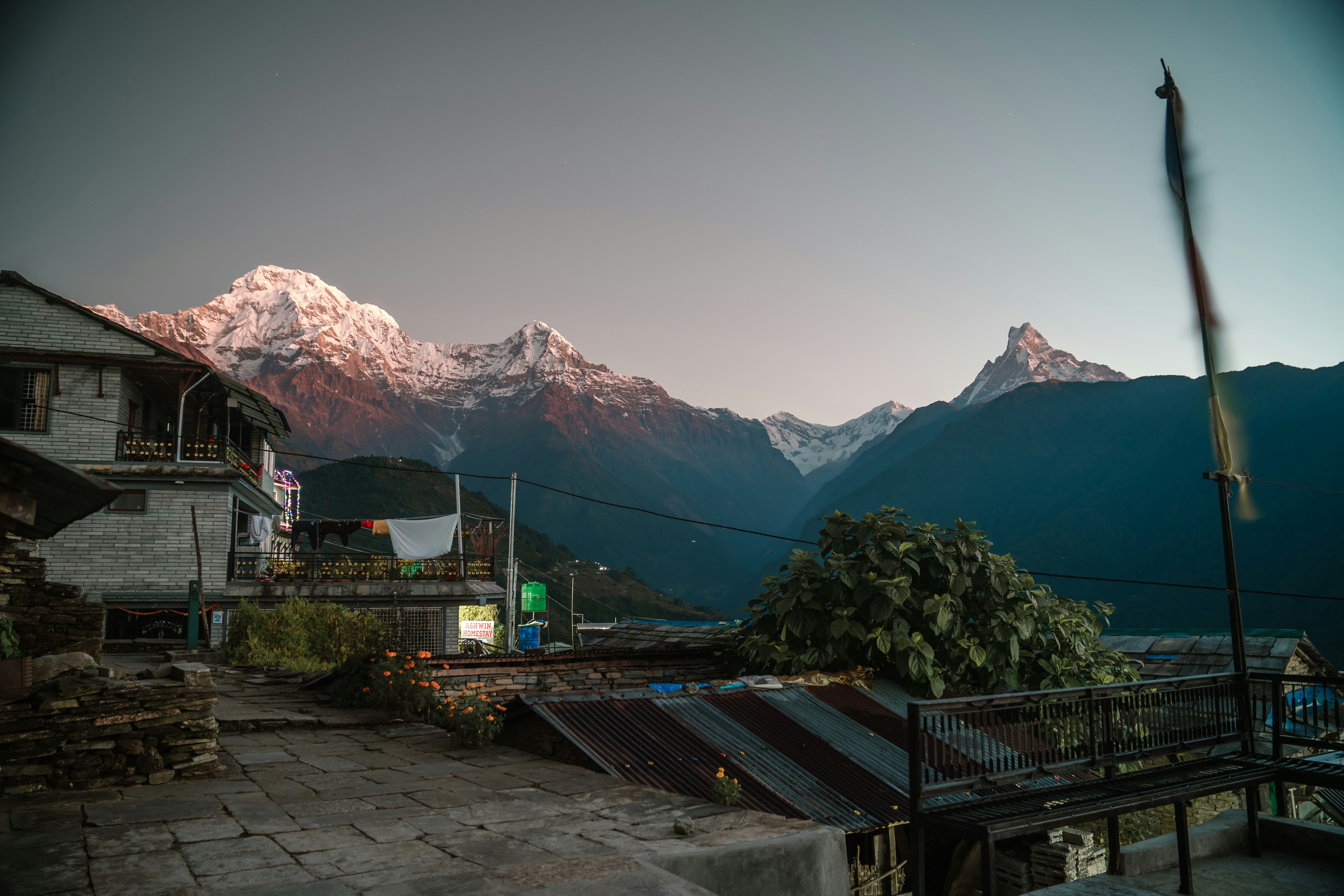 a view of a mountain range with a house in the foreground