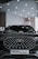 A sleek black SUV with a distinctive geometric grille pattern sits under a well-lit showroom ceiling. The vehicle prominently displays a badge in the center and a license plate reading 'TIGGO 8 PRO'.