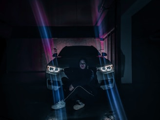 Technician installing car accessories in a bright garage.