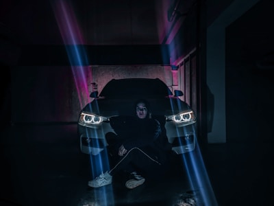 Technician installing car accessories in a bright garage.