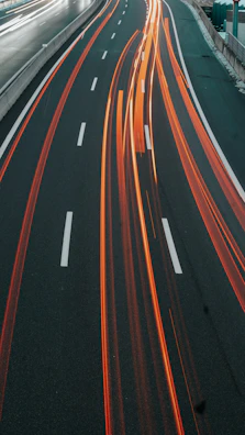 Dynamic night driving shot capturing motion blur on an empty highway.
