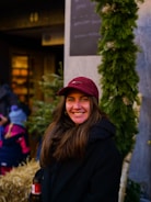 Smiling faces of people receiving warm clothing during a winter outreach.