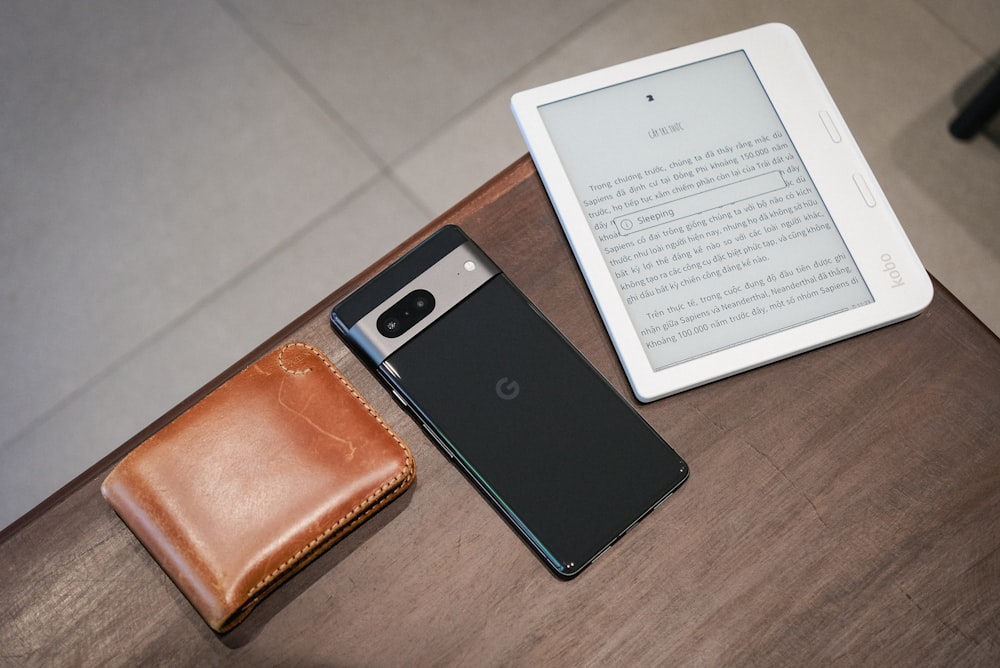 a tablet and a wallet sitting on a table
