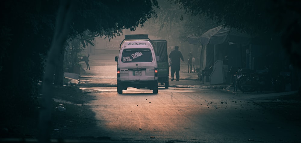 a van driving down a street at night