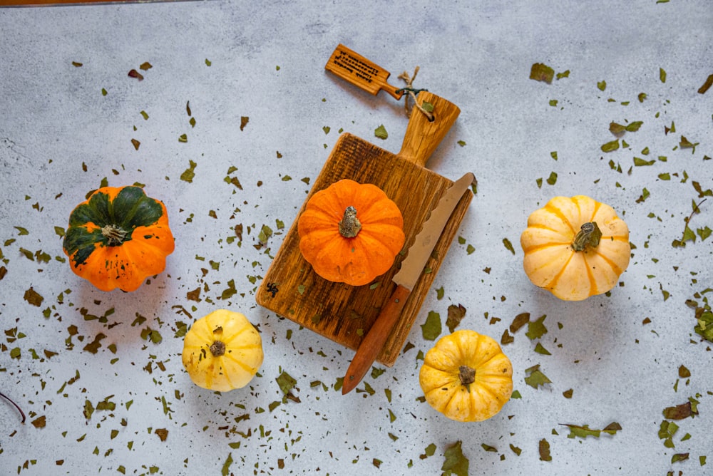 a bunch of small pumpkins sitting on a table