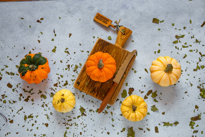 Small orange pumpkins on a table, similar to the mini pumpkins kids can decorate at the Summerlin Library fall festival