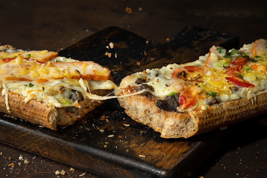 Cheesy baked pizza-style bites sliced and served on a cutting board