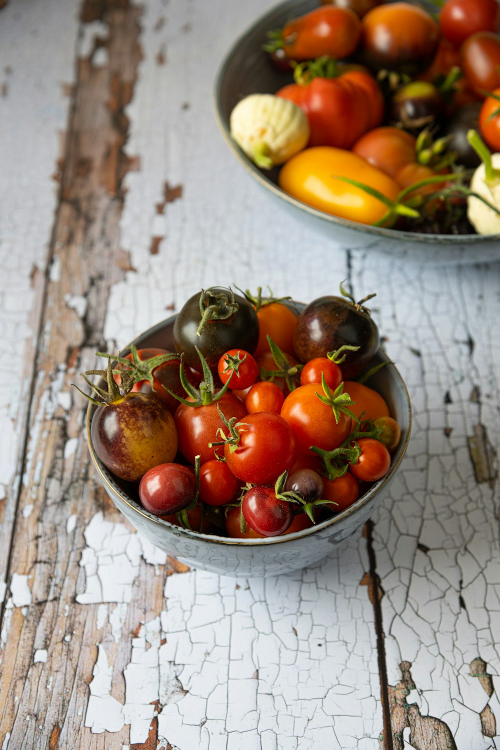 a couple of bowls filled with lots of different types of fruit