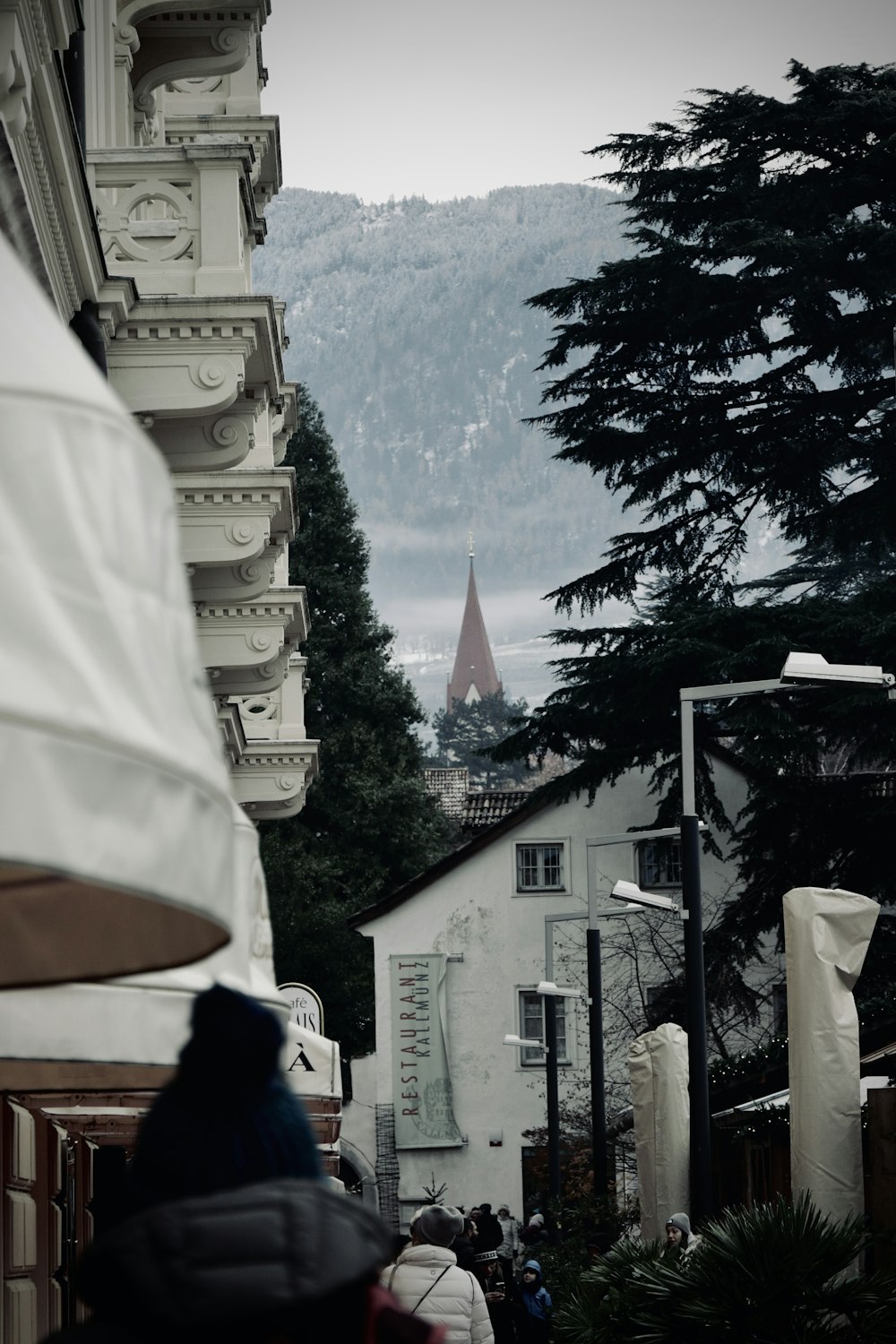 a person walking down a street with a clock tower in the background