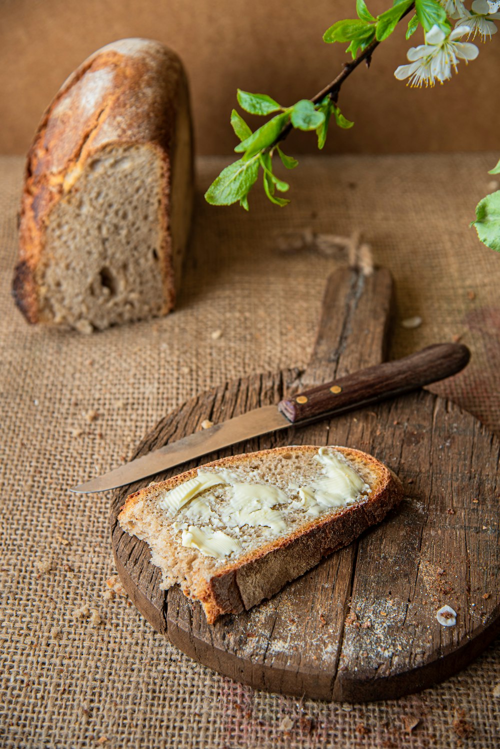 a loaf of bread sitting on top of a wooden cutting board