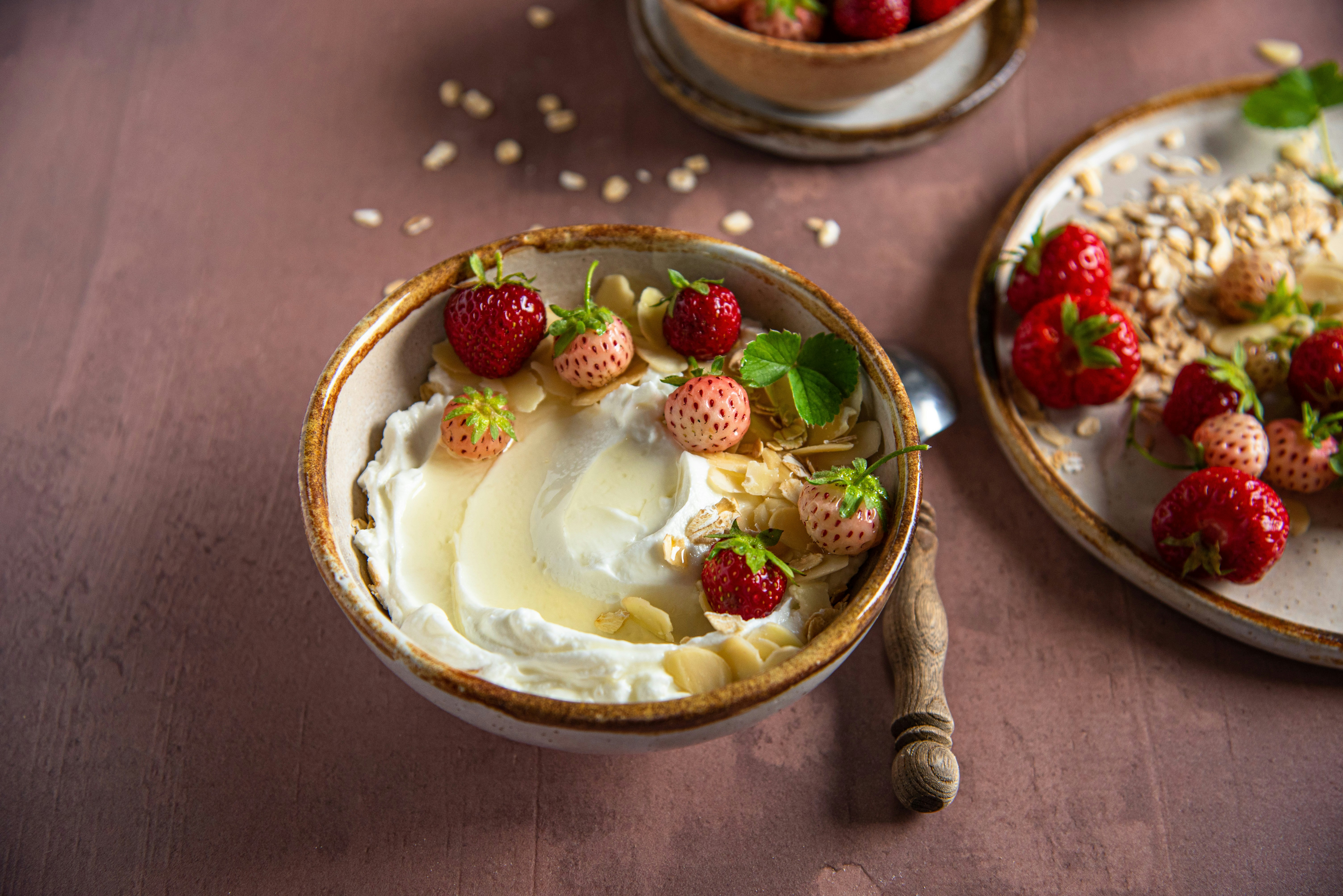 Greek yogurt with strawberries and granola—protein-rich snack for steady energy.