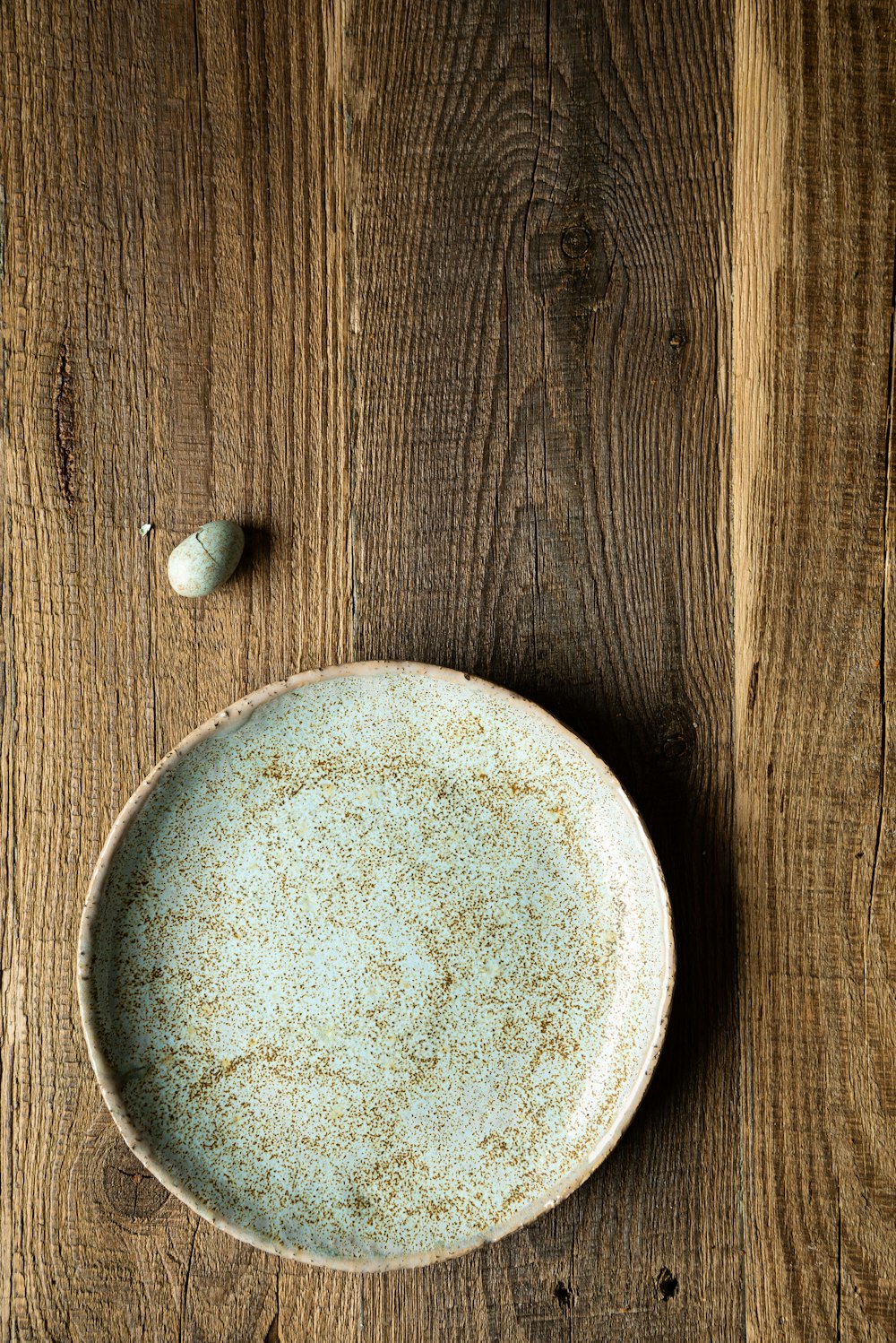 a plate and a spoon on a wooden table
