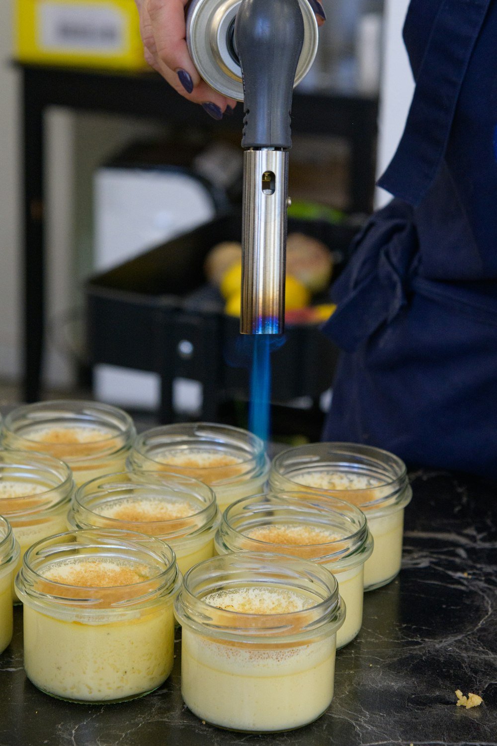 a person pours a liquid into small jars